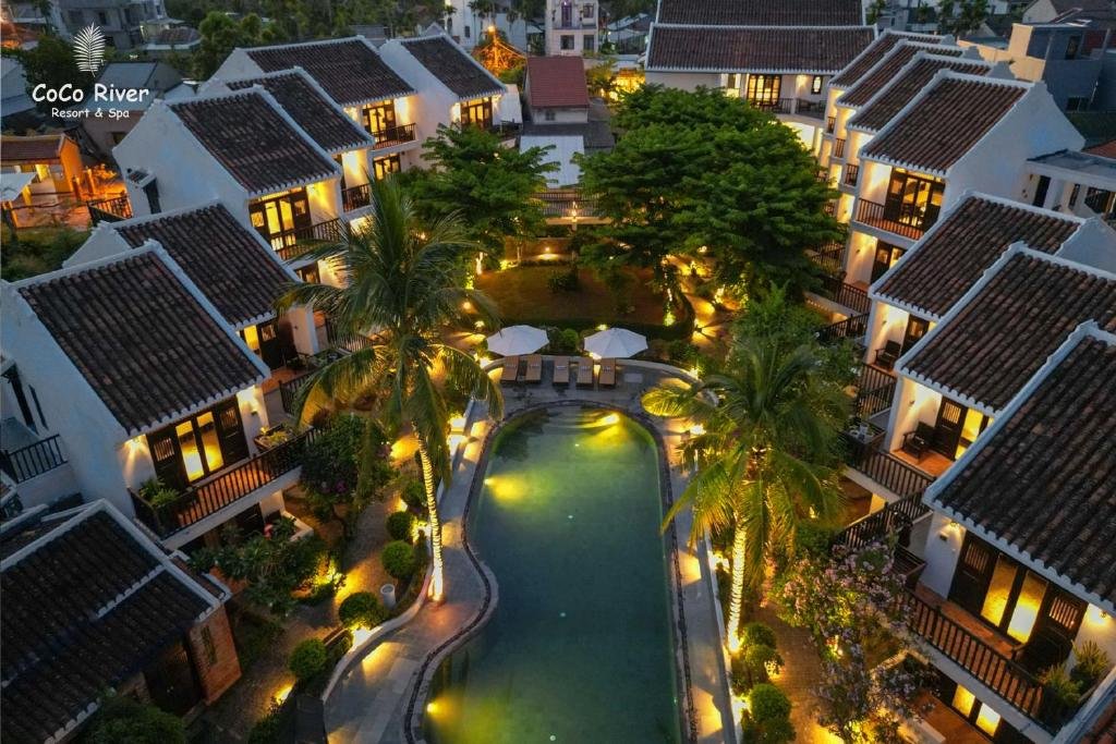 Hoi An Coco River Resort is surrounded by green coconut trees