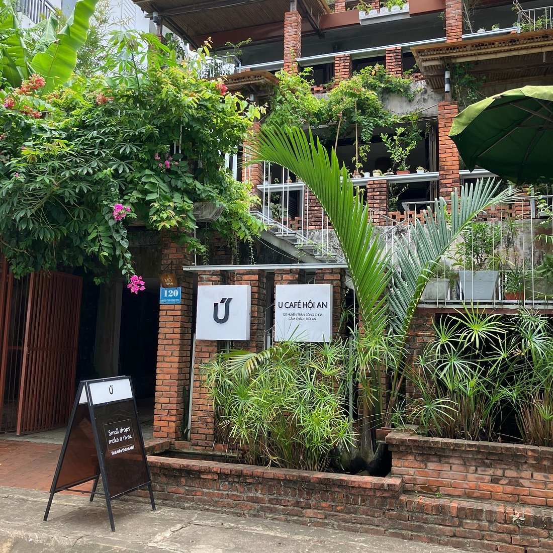 U Cafe Hoi An stands out with raw brick architecture, surrounding greenery, and a quiet space close to nature