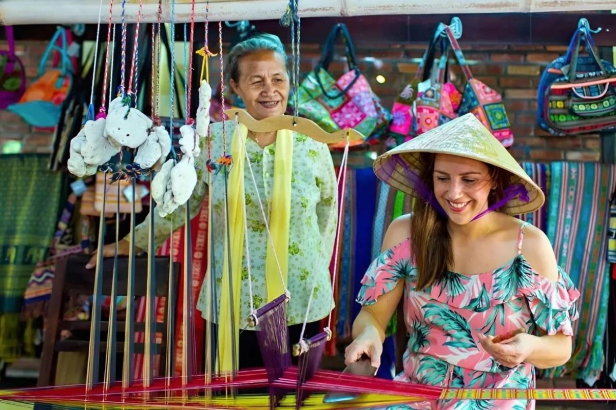 Visitors can manually weave silk under the guidance of artisans